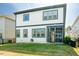 An expansive backyard features a covered porch, a well-kept lawn and black aluminum fence at 134 Cotten Dr, Morrisville, NC 27560