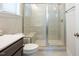 Modern bathroom featuring a sleek, glass-enclosed shower with bench, and contemporary fixtures at 134 Cotten Dr, Morrisville, NC 27560