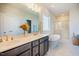 A bright bathroom featuring a double vanity, a luxurious bathtub, and marble floors at 134 Cotten Dr, Morrisville, NC 27560