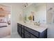 Spacious bathroom with a double sink vanity, large mirror, and access to the bedroom at 134 Cotten Dr, Morrisville, NC 27560