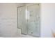 Bright bathroom featuring a luxurious shower with a glass enclosure and marble walls at 134 Cotten Dr, Morrisville, NC 27560