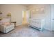 Inviting Bedroom with a crib, rocking chair, and round rug at 134 Cotten Dr, Morrisville, NC 27560