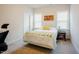 Bright bedroom with neutral walls and carpet, and two large windows at 134 Cotten Dr, Morrisville, NC 27560