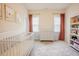 Bright Bedroom featuring a white crib, dresser, and bookshelf at 134 Cotten Dr, Morrisville, NC 27560
