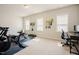 Bonus room features an office space and fitness center with bright natural light at 134 Cotten Dr, Morrisville, NC 27560