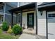 Close-up of a home's inviting front entry with manicured shrubs and a welcoming door at 134 Cotten Dr, Morrisville, NC 27560