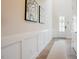 Bright hallway showcasing clean lines, wainscoting and modern decor with wood flooring at 134 Cotten Dr, Morrisville, NC 27560