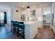 Bright kitchen featuring white cabinets, stainless steel appliances, and an island with barstool seating at 134 Cotten Dr, Morrisville, NC 27560
