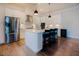 Kitchen showcasing stainless steel appliances, sleek white cabinets, and a functional island at 134 Cotten Dr, Morrisville, NC 27560
