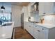 Modern kitchen boasts white cabinets, stainless steel appliances, and a stylish backsplash at 134 Cotten Dr, Morrisville, NC 27560