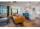 Open-concept living room featuring a leather couch, island with barstool seating and hardwood floors at 134 Cotten Dr, Morrisville, NC 27560