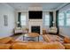 Inviting living room with a fireplace, a large television, and a comfortable leather sofa at 134 Cotten Dr, Morrisville, NC 27560