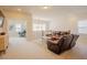 A bright and open living room featuring leather couches, neutral tones, and great natural lighting at 134 Cotten Dr, Morrisville, NC 27560