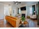 Comfortable living room with fireplace, TV, hardwood floors, and lots of natural light at 134 Cotten Dr, Morrisville, NC 27560