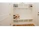 Well-organized mudroom featuring a built-in bench with hooks and shelving for organized storage at 134 Cotten Dr, Morrisville, NC 27560
