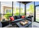 Relaxing screened porch featuring stylish wicker furniture and a comfortable seating area at 134 Cotten Dr, Morrisville, NC 27560