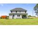 Large two-story home with siding, a deck, and an expansive backyard with manicured lawn at 1412 Main St, Lillington, NC 27546