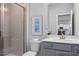 Bathroom features a glass shower, gray vanity, and neutral finishes at 1412 Main St, Lillington, NC 27546