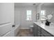 Bathroom with bathtub, a toilet, and sink vanity with a window letting in natural light at 1412 Main St, Lillington, NC 27546
