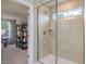 Tiled stand up shower, with a glass door and chrome fixtures, inside a naturally lit bathroom at 1412 Main St, Lillington, NC 27546