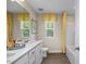 Bathroom featuring double vanity, granite countertop, patterned window valances, and a tub with shower at 1412 Main St, Lillington, NC 27546