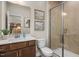Modern bathroom featuring a glass enclosed shower, decorative wall art, and a sleek vanity at 1412 Main St, Lillington, NC 27546