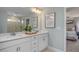 Bright bathroom with a double vanity, quartz countertops, framed mirror and an adjacent bedroom for seamless transition at 1412 Main St, Lillington, NC 27546