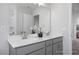 Bathroom with a large double vanity, neutral walls and carpet, and a mirror above the sinks at 1412 Main St, Lillington, NC 27546