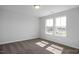 This empty bedroom features neutral paint and carpet, as well as two large windows for ample natural light at 1412 Main St, Lillington, NC 27546