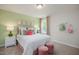 A beautifully decorated bedroom with a queen-size bed, accent pillows, soft lighting and plush carpet at 1412 Main St, Lillington, NC 27546