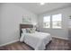 Cozy bedroom with natural light, neutral decor, and comfortable furnishings at 1412 Main St, Lillington, NC 27546