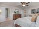 Spacious bedroom featuring a dresser, and a comfortable bed with a ceiling fan, with a walk-in closet at 1412 Main St, Lillington, NC 27546