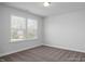 Empty bedroom with neutral paint and carpet, two large windows letting in ample natural light at 1412 Main St, Lillington, NC 27546