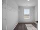 Walk in closet featuring shelving, neutral walls and carpet, and a window letting in natural light at 1412 Main St, Lillington, NC 27546