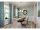 Bright dining room features a chandelier, accent wall, and large windows with patterned curtains at 1412 Main St, Lillington, NC 27546