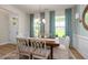 Cozy dining room filled with natural light through the windows, featuring modern decor and a stylish chandelier at 1412 Main St, Lillington, NC 27546