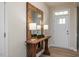 Welcoming entryway features a wood console table, oversized mirror, and a front door with glass panels at 1412 Main St, Lillington, NC 27546