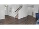 Hallway features wood flooring, staircase, and an open floor plan leading to other parts of the home at 1412 Main St, Lillington, NC 27546