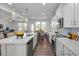 Open-concept kitchen flows into the dining and living areas, with bright natural light and stylish pendant lighting at 1412 Main St, Lillington, NC 27546