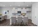 Open kitchen with white cabinetry, a center island, and modern pendant lighting at 1412 Main St, Lillington, NC 27546