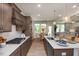 Open-concept kitchen with a center island, stainless steel appliances, custom cabinets, and an adjacent dining area at 1412 Main St, Lillington, NC 27546