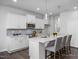 Stylish kitchen featuring white cabinets, stainless steel appliances, and a breakfast bar at 1412 Main St, Lillington, NC 27546