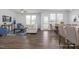 Open-concept living room with wood floors and lots of natural light at 1412 Main St, Lillington, NC 27546