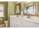 Ensuite bathroom with dual sinks, framed mirrors, and white cabinetry at 1427 Van Page Blvd, Raleigh, NC 27607