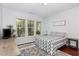 Bright bedroom featuring natural light from the windows and hardwood floors, decorated with a 'Be our guest' sign at 1427 Van Page Blvd, Raleigh, NC 27607