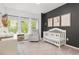Cozy Bedroom features a crib, a changing table, and a comfortable rocking chair at 1427 Van Page Blvd, Raleigh, NC 27607