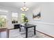 Bright dining area with modern table, chairs, and views from the windows at 1427 Van Page Blvd, Raleigh, NC 27607