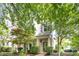 Charming brick townhome featuring a welcoming covered porch and well-maintained landscaping at 1427 Van Page Blvd, Raleigh, NC 27607