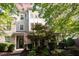 Inviting townhome showcasing manicured landscaping, brick accents, and a charming covered entrance at 1427 Van Page Blvd, Raleigh, NC 27607