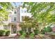 Inviting townhome showcasing manicured landscaping, brick accents, and a charming covered entrance at 1427 Van Page Blvd, Raleigh, NC 27607